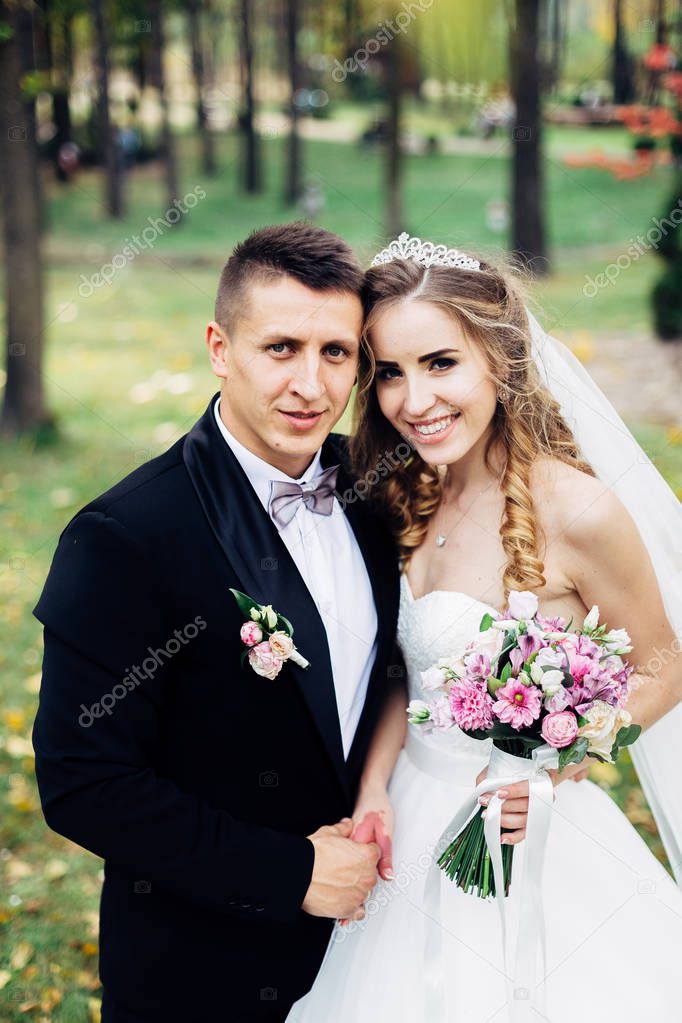 Great portrait of a wedding couple, which is walking in the park