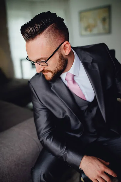 Portrait of a handsome groom in a grey suit with a tie. — Stock Photo, Image