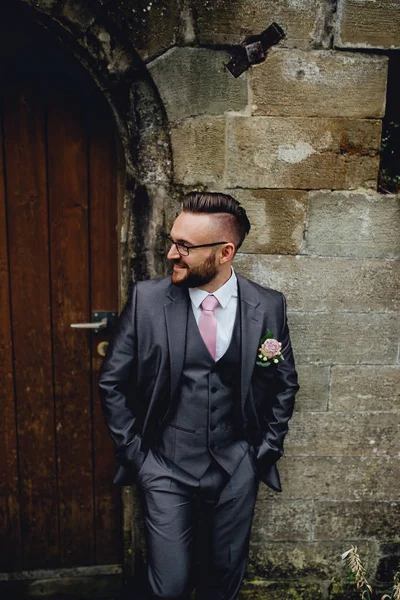Portrait of a handsome groom in a grey suit with a tie and vest. — Stock Photo, Image