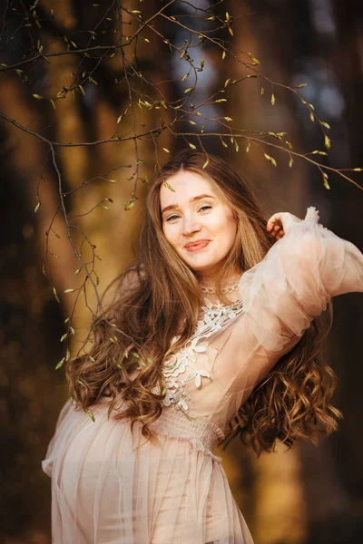 Belo retrato de uma mulher grávida na floresta . — Fotografia de Stock