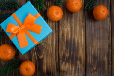 Mandalina ve kahverengi ahşap zemin üzerinde Hediyelik Noel kompozisyonu. Üstten görünüm. Kopya alanı.