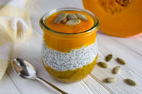 Pudding with chia and  pumpkin  on the white  wooden background