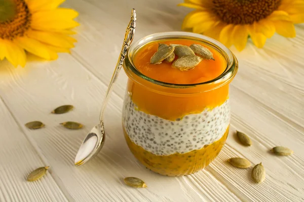 Pudding with chia and  pumpkin  on the white  wooden background