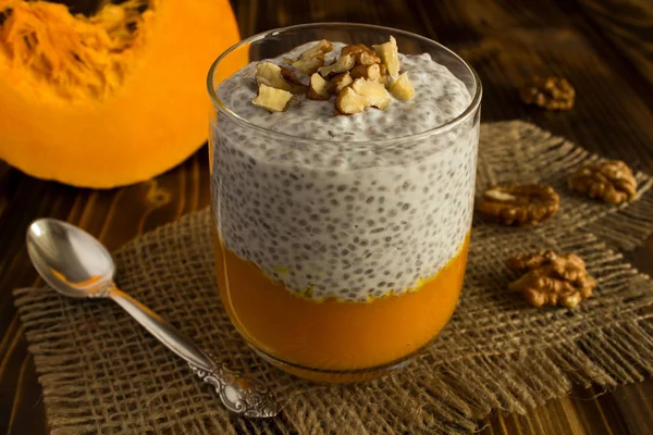 Pudding with chia,pumpkin  and walnuts  on the rustic wooden background