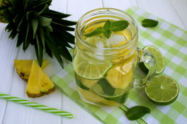 Detox water with pineapple  and  lime on  the green napkin