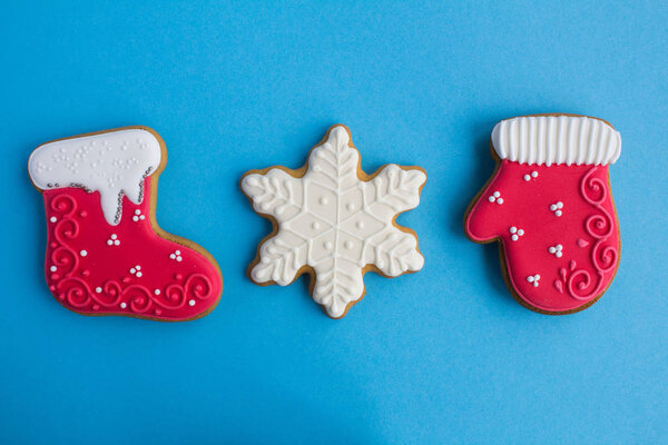 Christmas composition with gingerbread on the  blue background. Top view. Copy space.