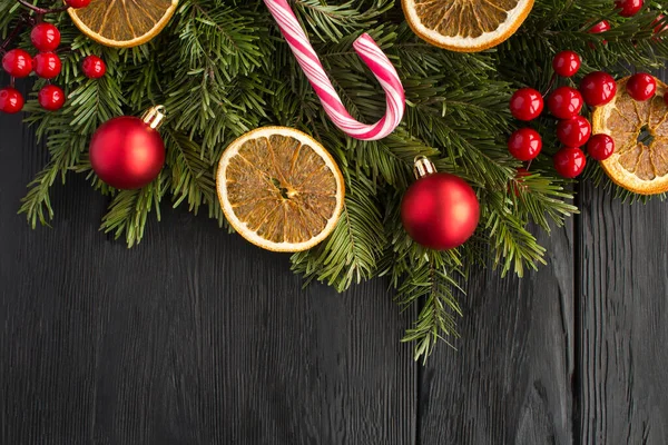 Christmas ring or wreath on the black wooden background. Top view. Copy space.