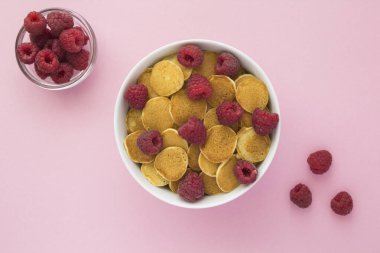 Pembe arka planda beyaz kasede ahududu olan mini krep manzarası.