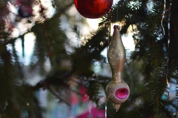 Vintage Christmas toys on a festive tree. Icicle with a ball.