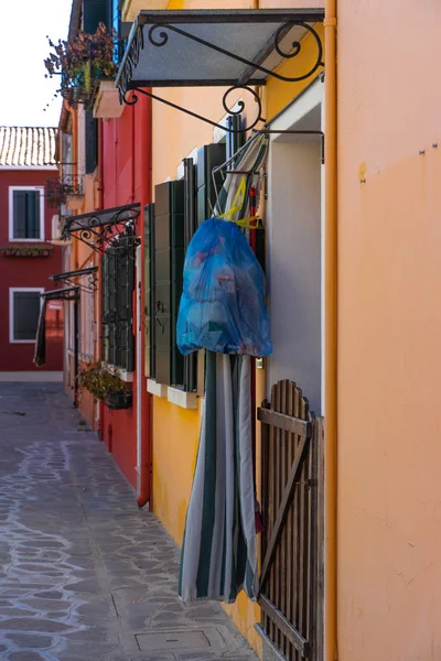 Maisons colorées de l'île de Burano. Venise. Rue typique avec buanderie suspendue aux façades de maisons colorées — Photo