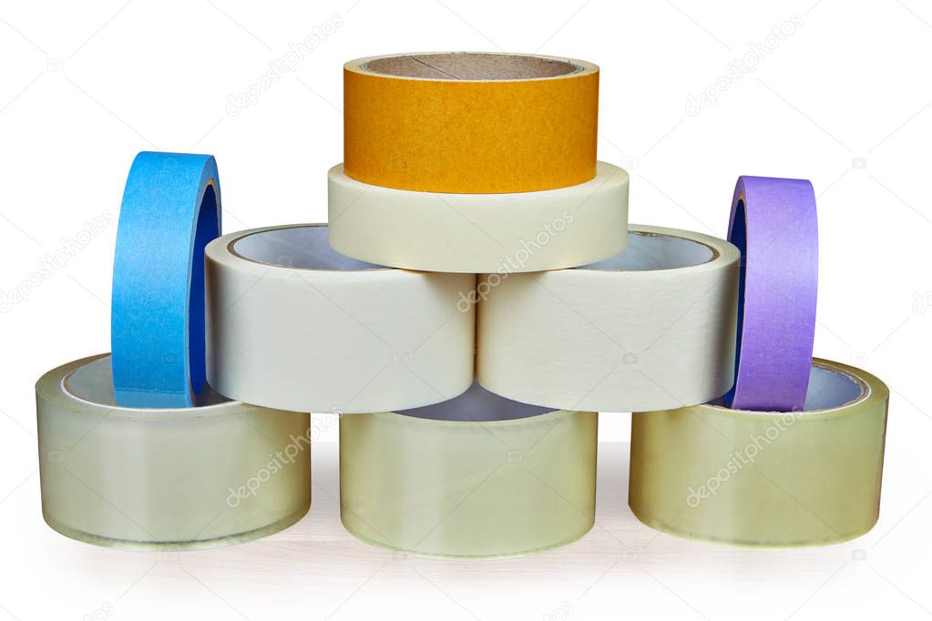 Many rolls of scotch packing tape, and masking tape is stacked in form of pyramid, isolated on white background, with saved path.