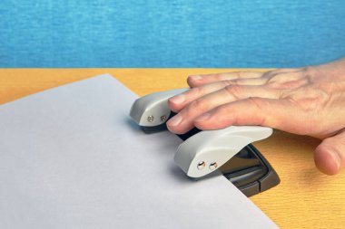 Ofiste belgelerle çalışmak için kullanılan bir yumruk delik kişi presler.