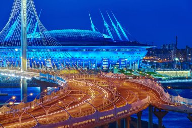 St. Petersburg, Russia - August 22, 2018: Saint Petersburg Arena, where the World Cup was and cable-stayed bridge in blue hour. clipart