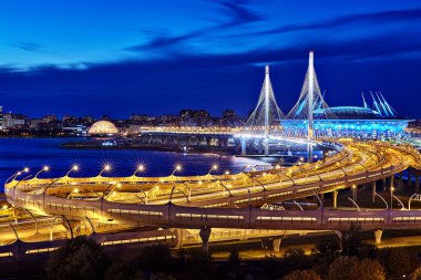St. Petersburg, Russia - August 22, 2018: Panorama of St. Petersburg - view of the cable-stayed bridge, the western high-speed diameter and stadium St. Petersburg in blue hour. clipart