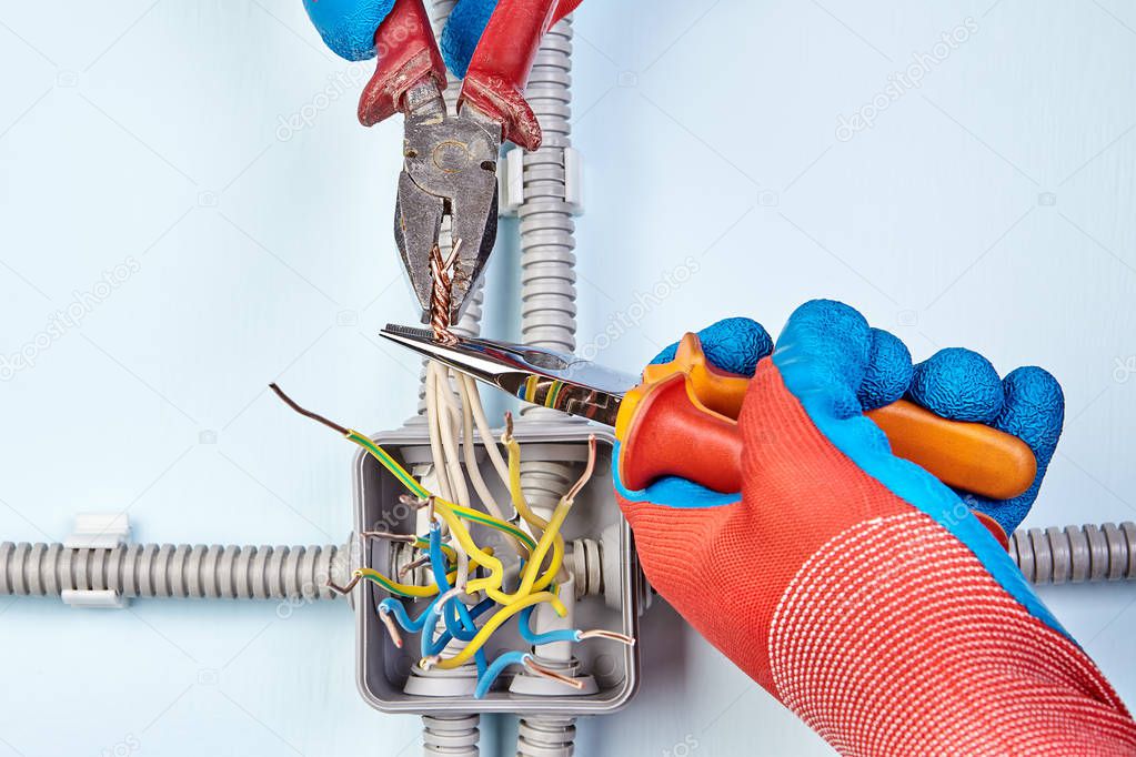 Electrician is joining wires together by work tools.