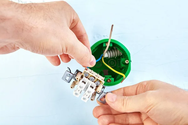 Installation of electrical socket box inside drywall wall. — Stock Photo, Image