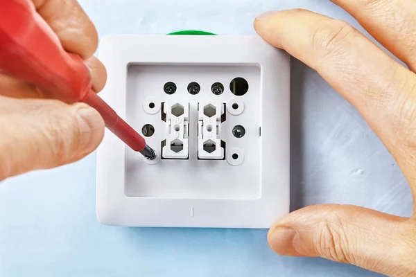 Twisting screw in european light switch. — Stock Photo, Image