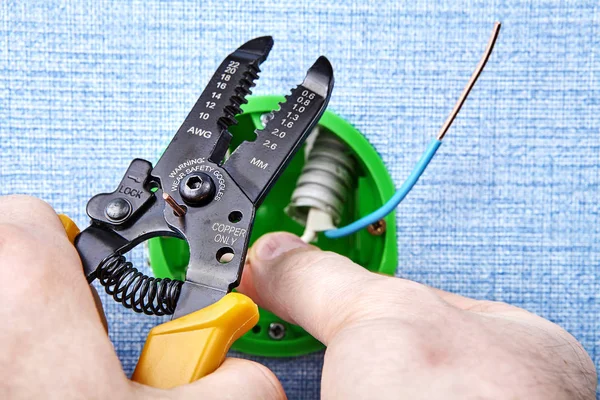 Repairman installs round electrical box. — Stock Photo, Image