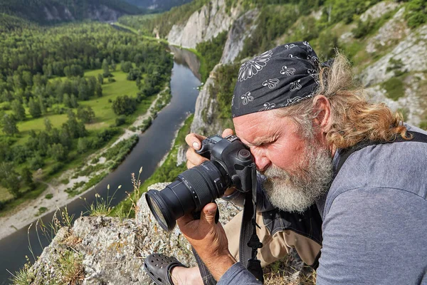 Reifer Mann fotografiert die Natur. — Stockfoto