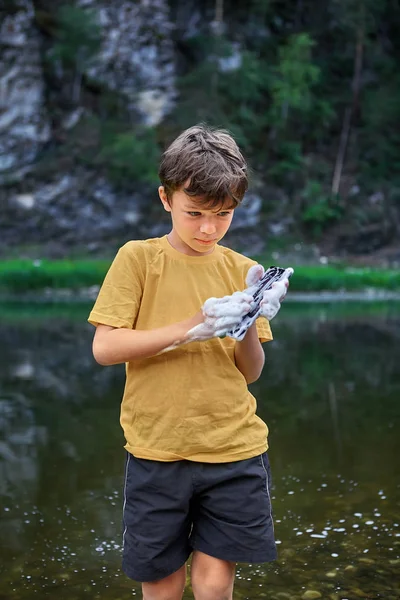 Removing dirt from the screen of a mobile phone.