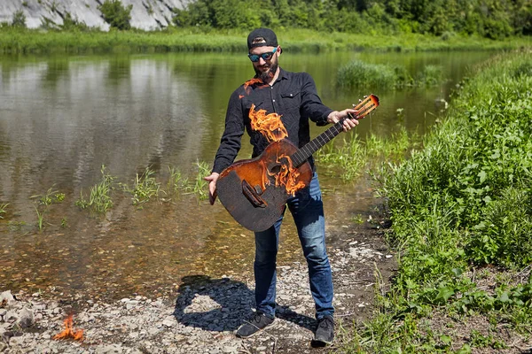 The musician is afraid to play a burning guitar.