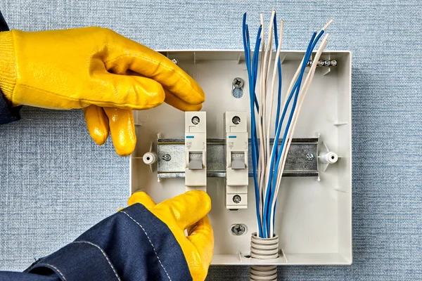 Installing protective devices in electrical panel.