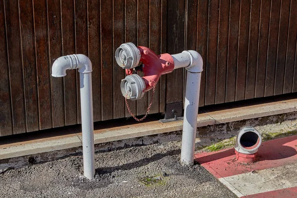 Underground fuel storage with pressure relief pipe and fire hydrant.