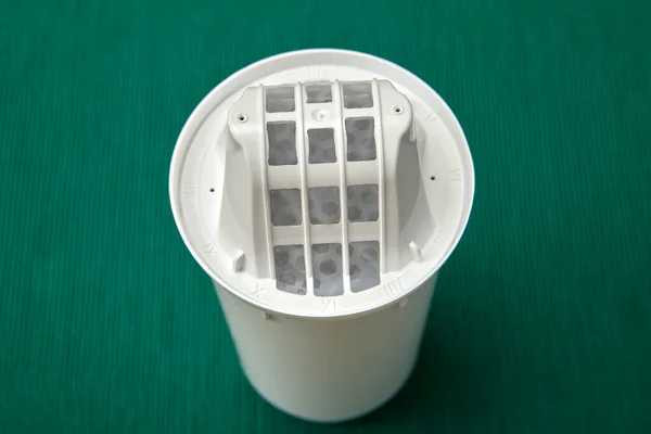 Replaceable module, or cartridge for a filter jug on a green background. Domestic tap water purifier.