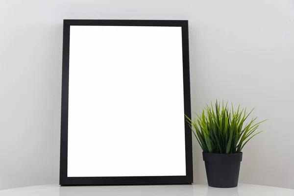 Empty Modern Black Frame White Glossy Table Decorative Grass Flowerpot — стоковое фото