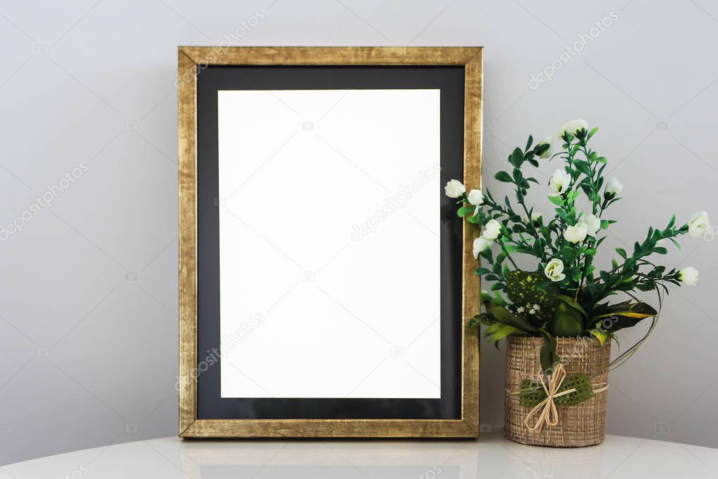 Empty Frame On Wooden Shelf With Decorative Flowers,Vintage Box and Antique Vase Gray Background Wall