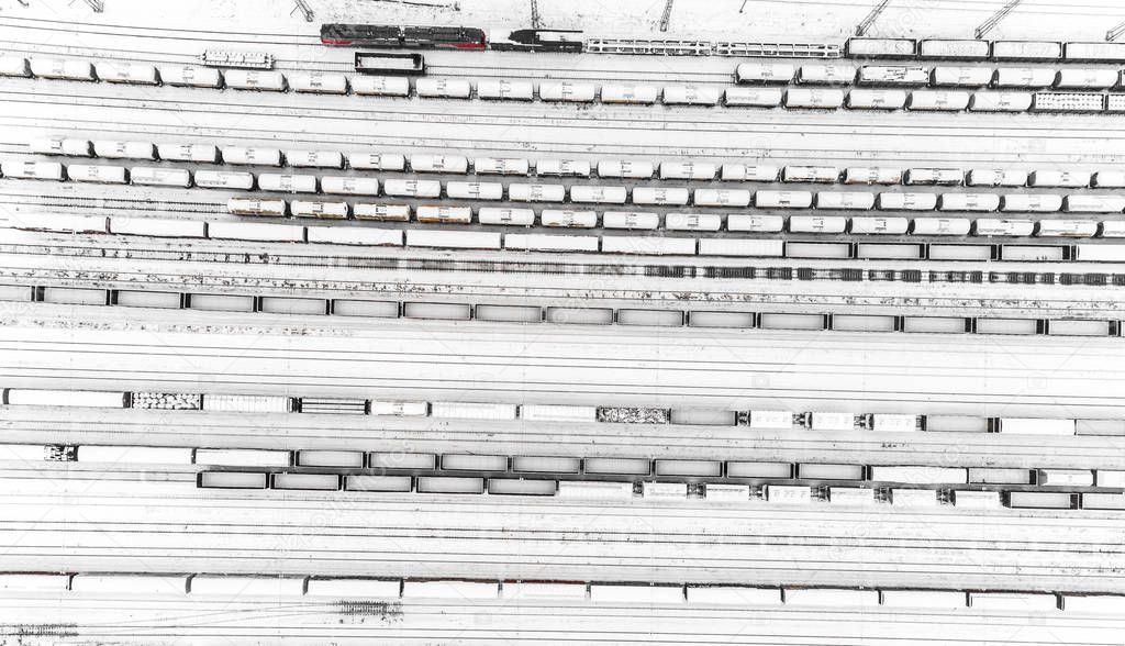 Aerial view of freight train yard covered in snow