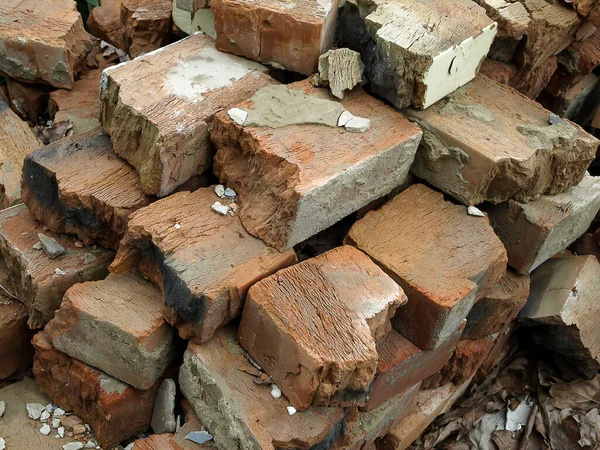 Old broken bricks piled in a pile