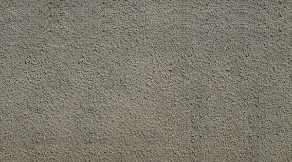 Gray concrete wall with relief in the form of tubercles