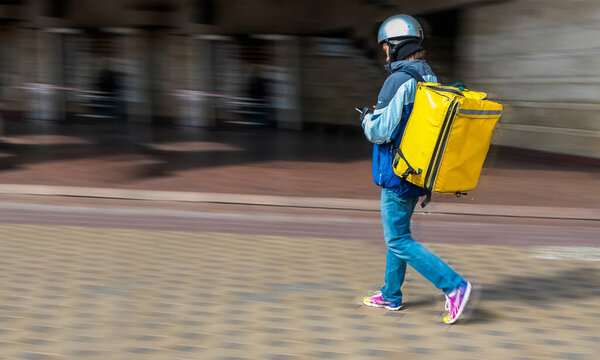 Motion blur, Courier walking down the street