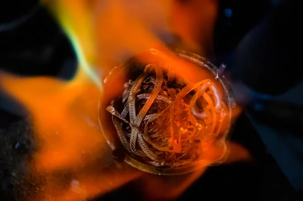 smelting precious metal of silver or gold. remelting of jewelry in a crucible with a torch at a jewelers workplace. jewelry making