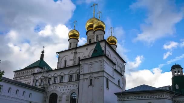 Timelapse of the church with blue sky background and moving clouds. 4K video with zoom out from the object. — Stock Video