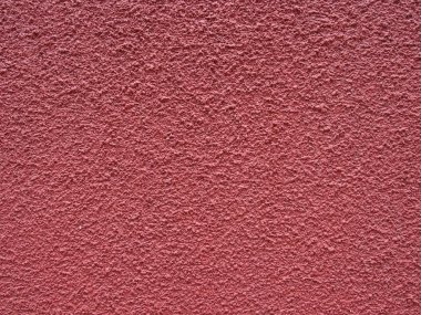Soluk kırmızı koyu pembe pürüzlü dokulu boyalı beton duvar yüzeyi