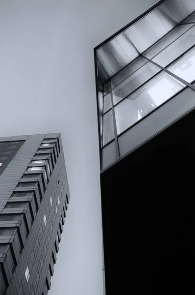 abstract view of office buildings at night looking upwards with lights in the windows