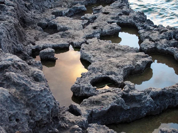 ening sky reflected in rock pools