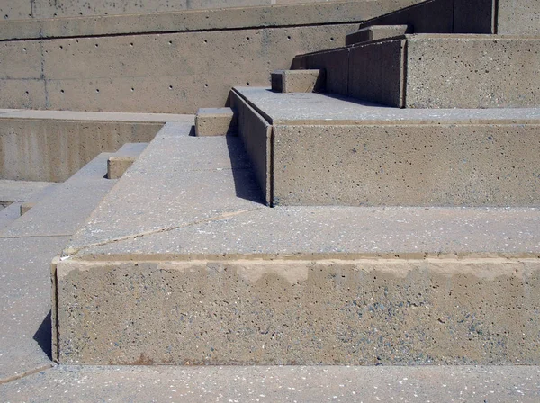 close up of modern outdoor angular concrete stairway with geometric shapes in bright sunlight