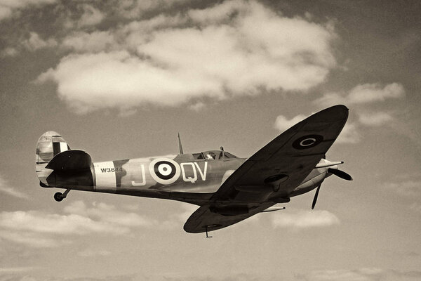 Blackpool, Lancashire, England - June 10 2018: Vintage world war 2 Mark Vb spitfire in flight againt a blue sky with clouds
