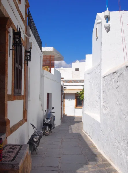 Whitewashed village street in afandou in rhodes with blue shy do — Stock Photo, Image