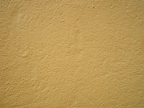 Szorstka teksturowana ziarnistego bladożółtego betonu ściany tła powierzchni podłogi — Zdjęcie stockowe