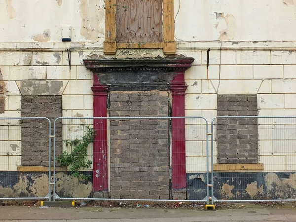 derelict abandoned house on the street with barriers in wakefiel