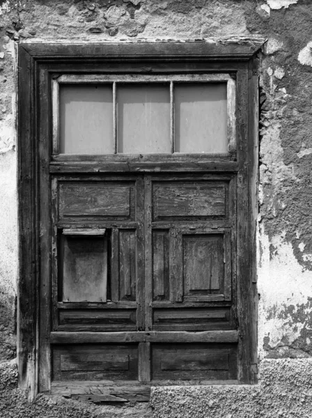 Half shuttered old shabby window in a decaying house with weathe — Stock Photo, Image