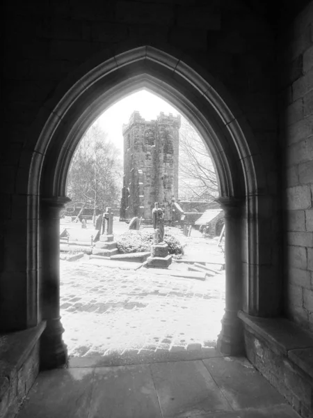The ruined church of heptonstall through an archway in falling s — Stock Photo, Image