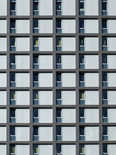 Modern concrete housing development with repeating pattern windows