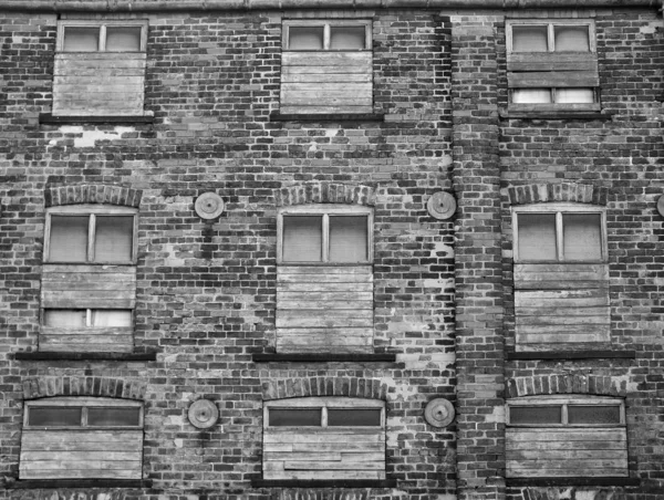 Gran edificio de ladrillo viejo con ventanas tapiadas — Foto de Stock