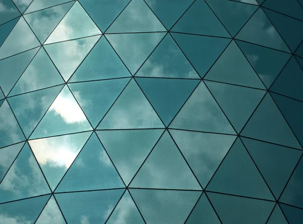 angular mirror cladding on a modern structure with reflected sky