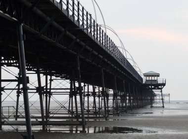southport pier showing beach and structure in the evening clipart
